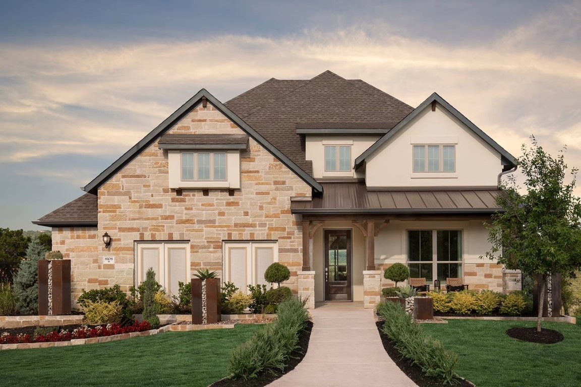 a front view of a house with garden