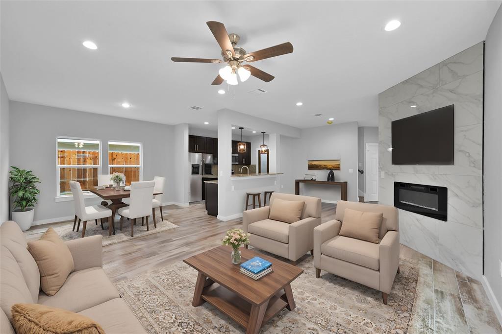 a living room with furniture fireplace and a flat screen tv