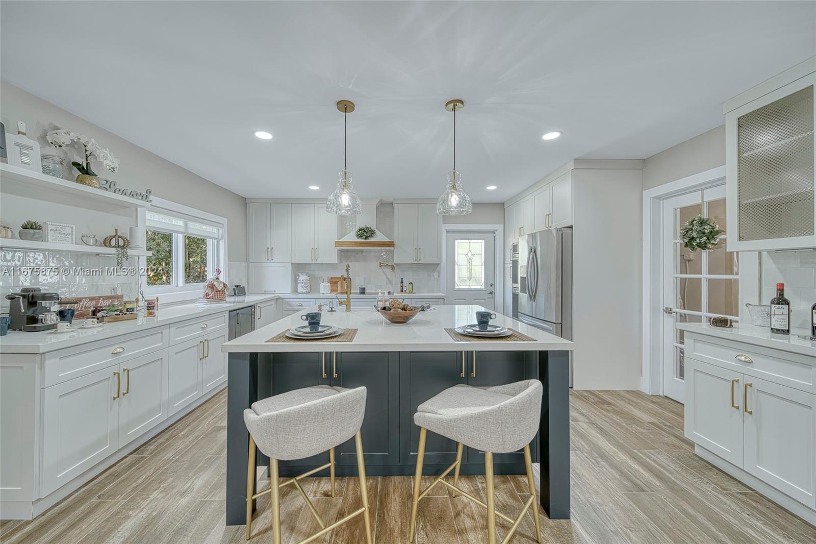 a kitchen with a sink and chairs