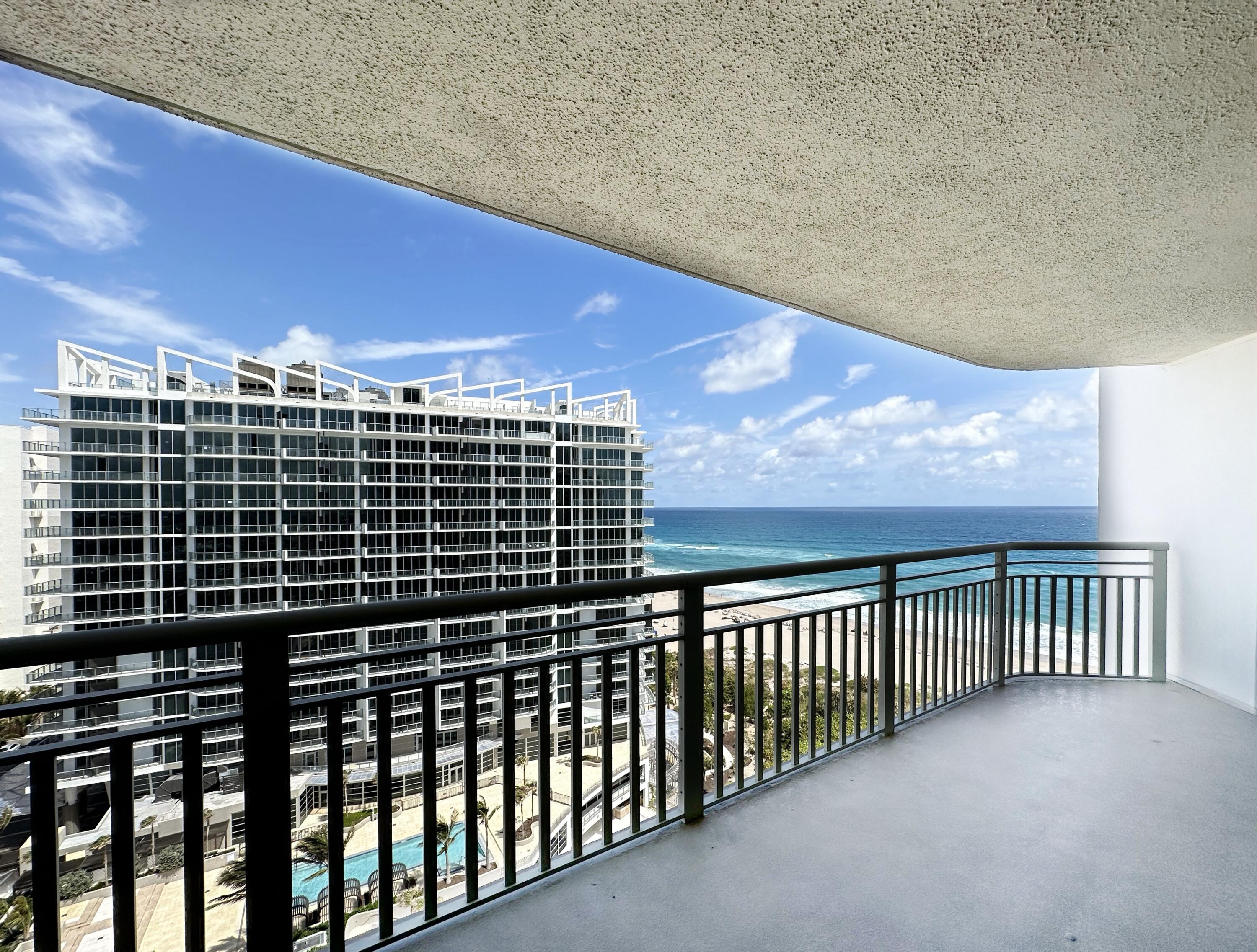 a view of balcony with floor to ceiling windows