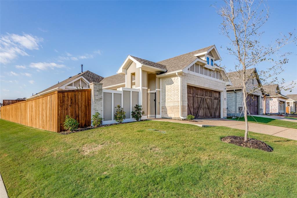 a view of a house with a yard and wooden fence