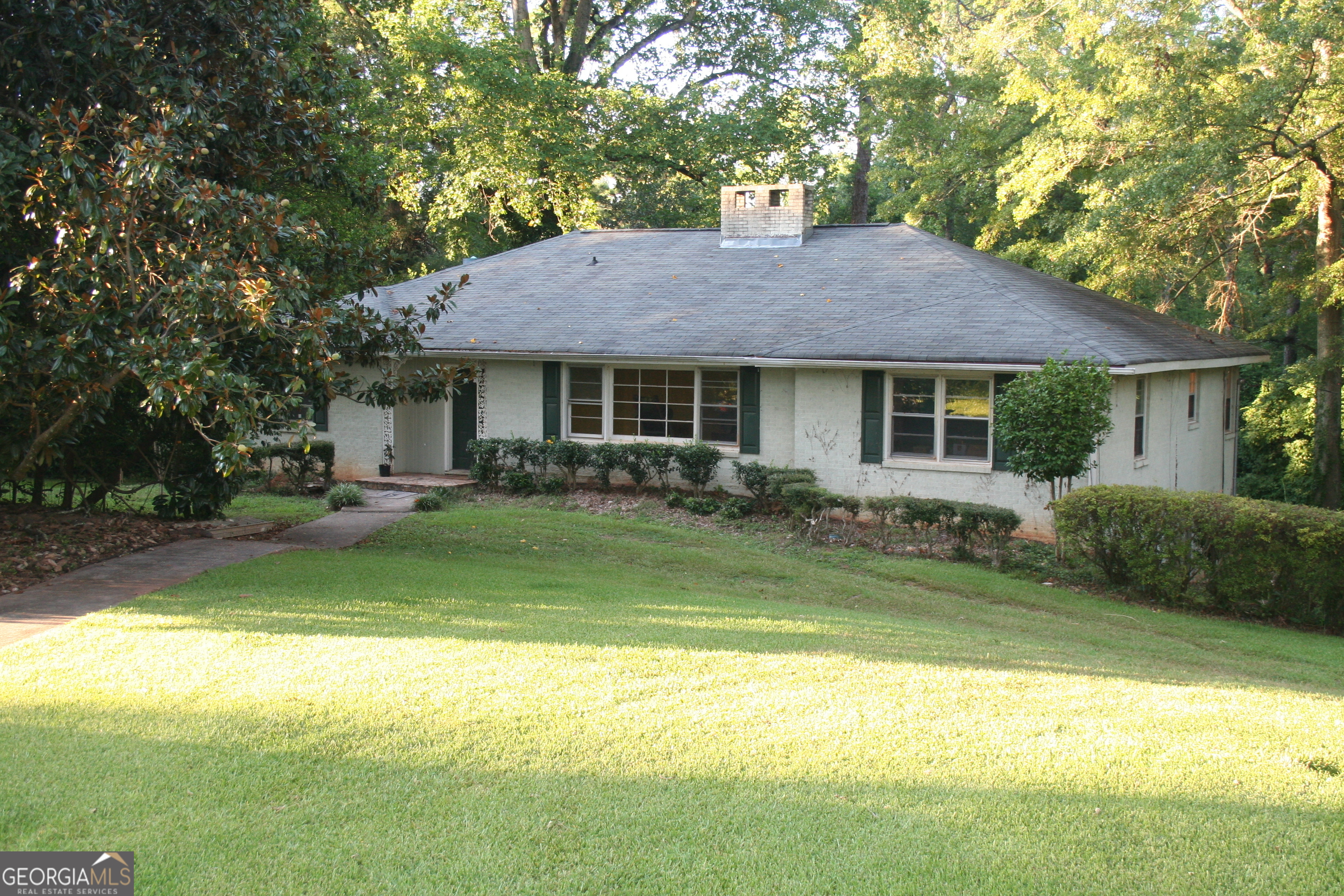 a front view of a house with swimming pool and porch