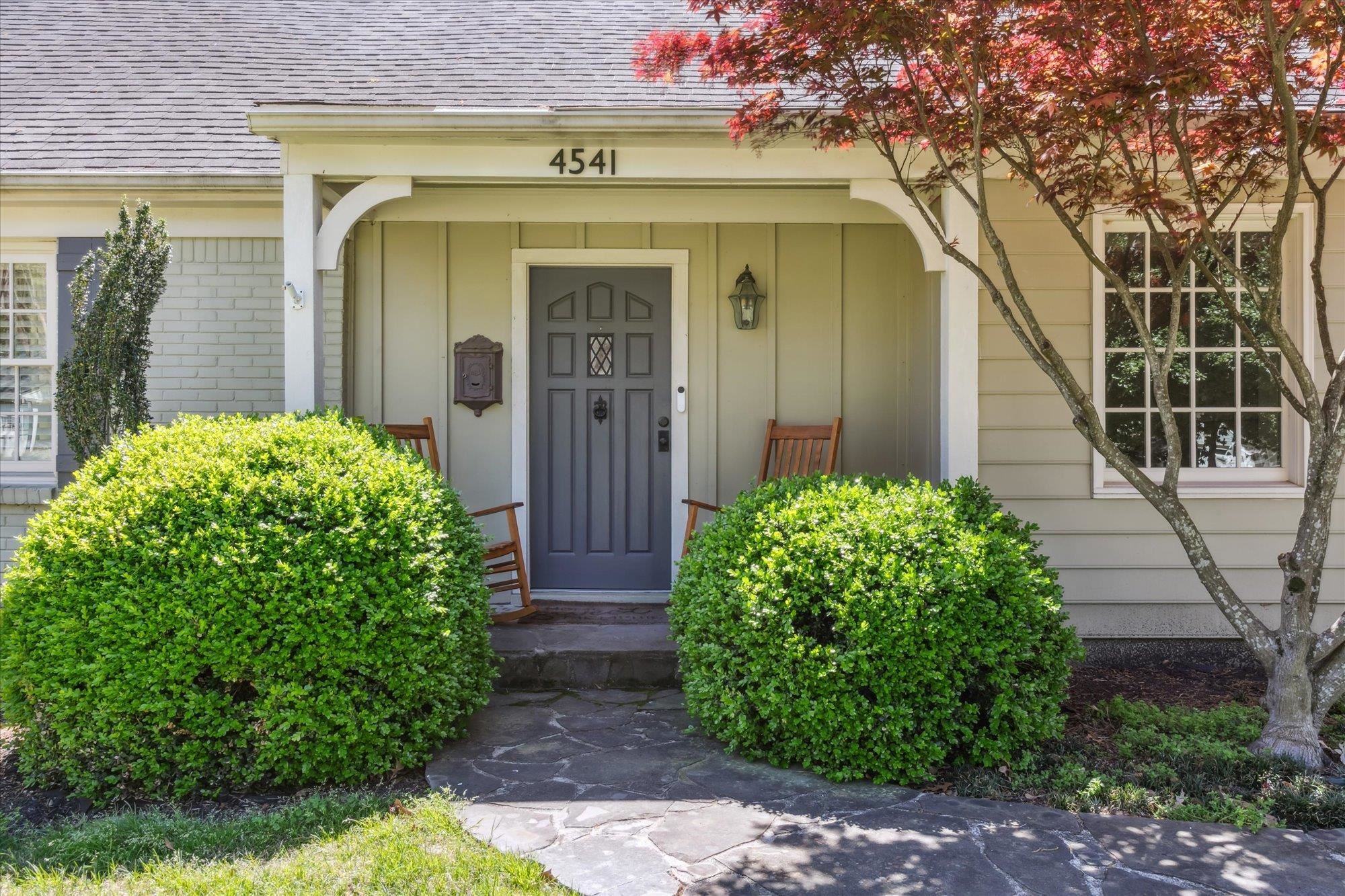 a front view of a house with garden