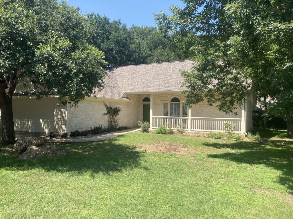 a backyard of a house with yard and tree