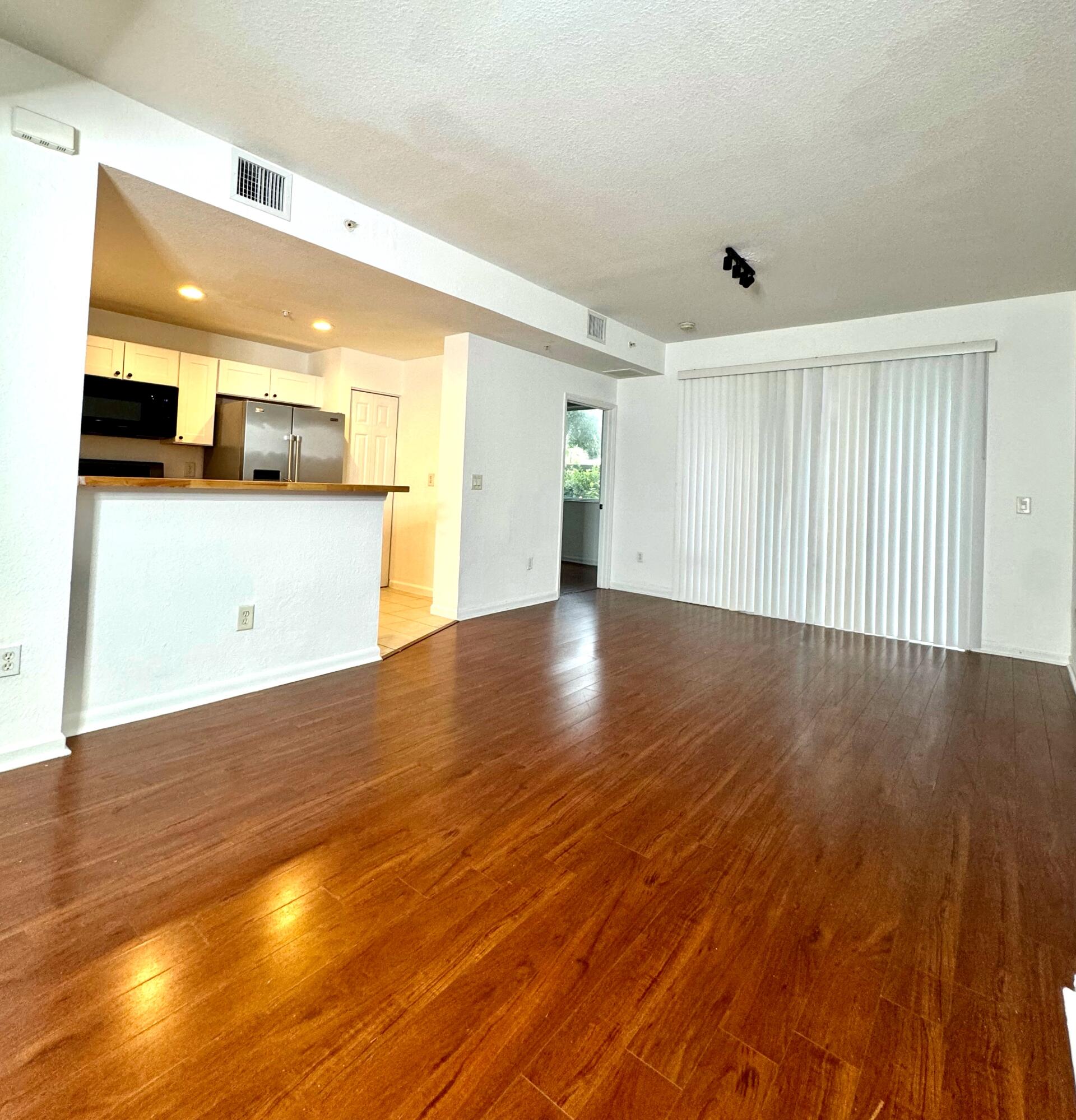 a view of a kitchen with a sink and wooden floor