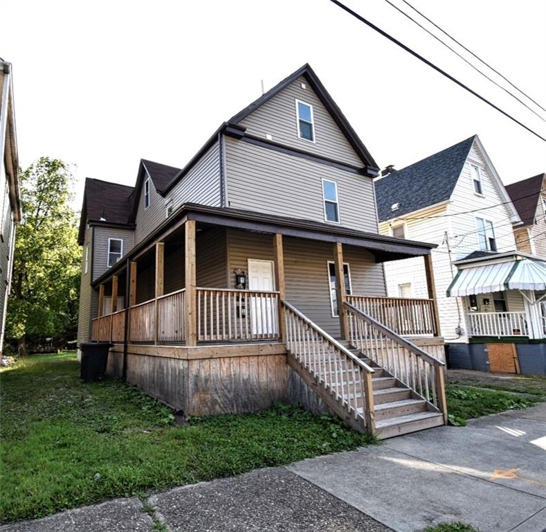 a view of a house with a yard next to a house