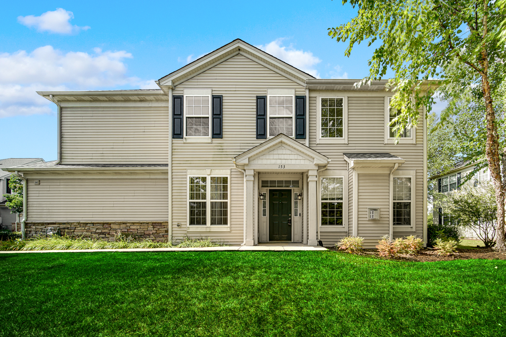 front view of a house with a yard