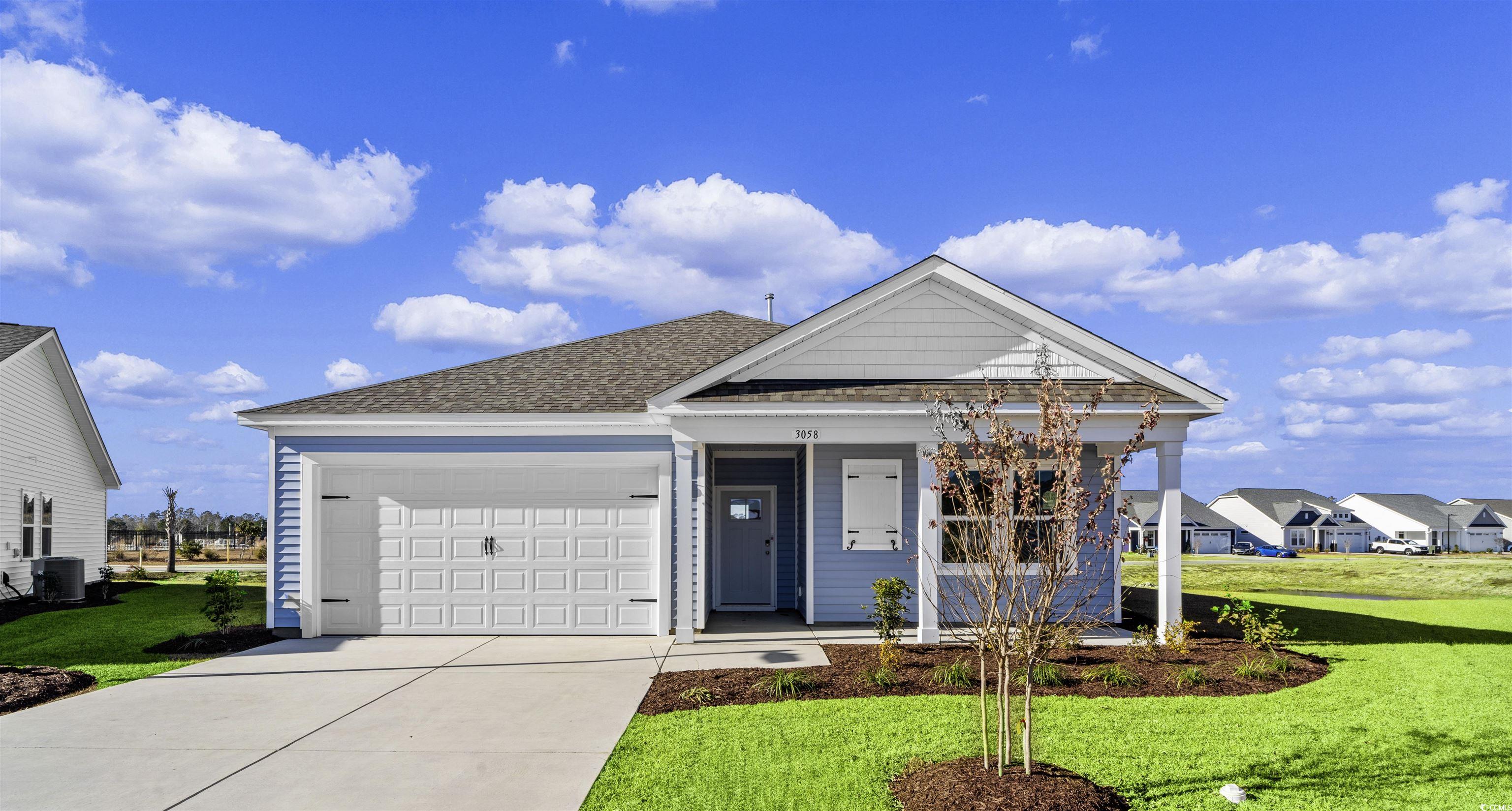 View of front facade with central AC, a garage, an