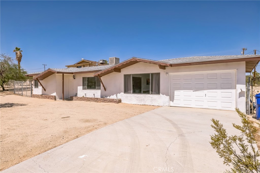 a front view of a house with a dirt yard