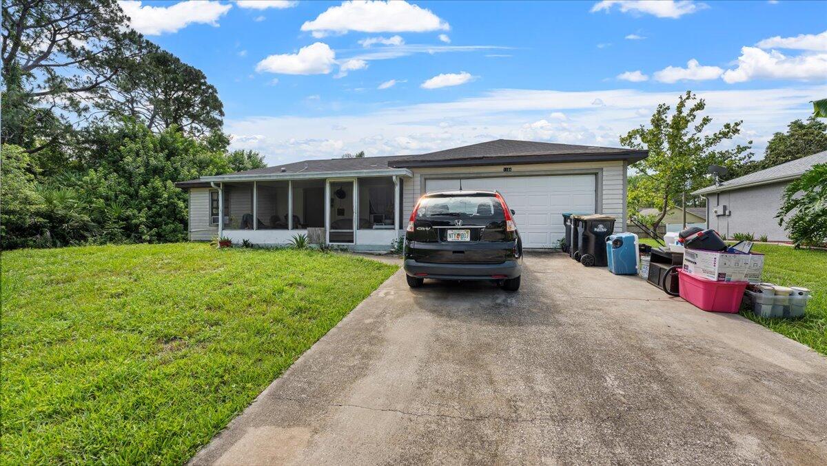 a view of a house with backyard and sitting area