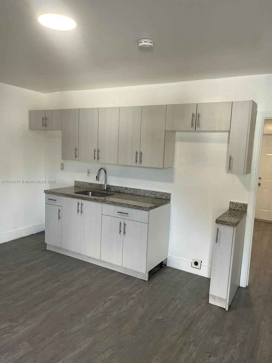 a kitchen with a sink and a refrigerator