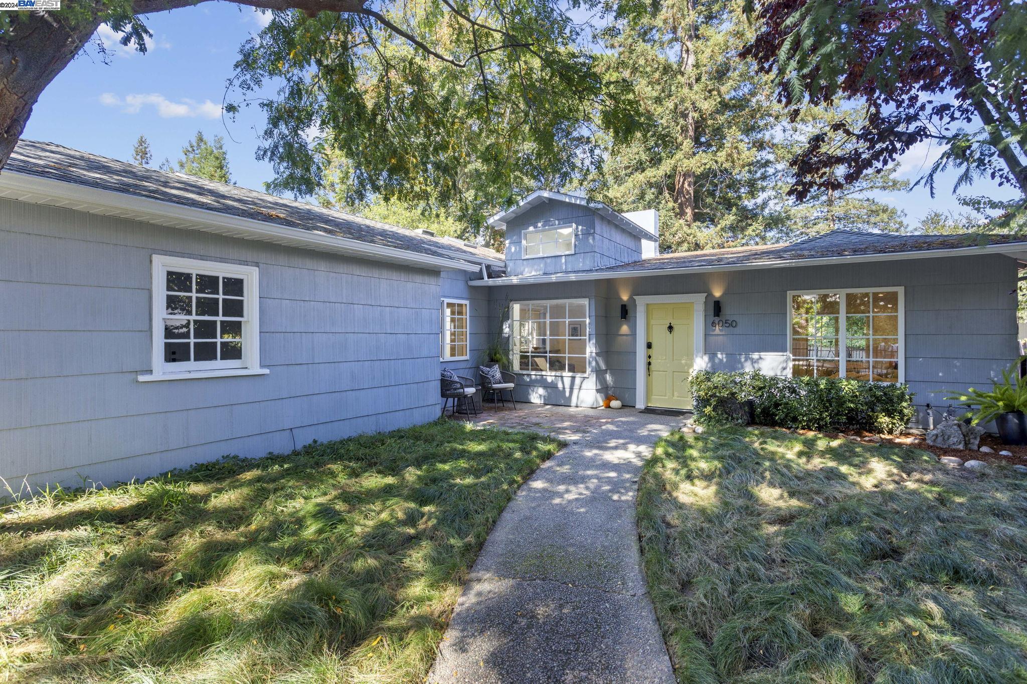 a front view of a house with a garden