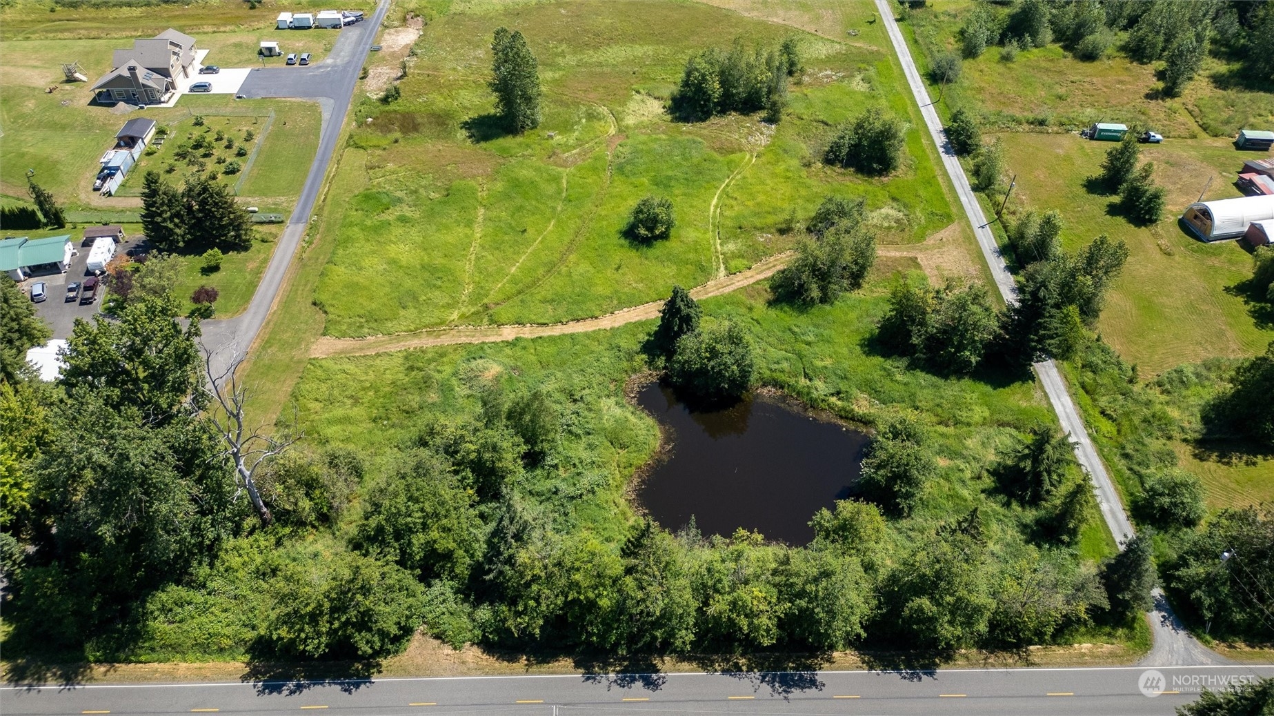 an aerial view of residential house with pool yard and outdoor seating