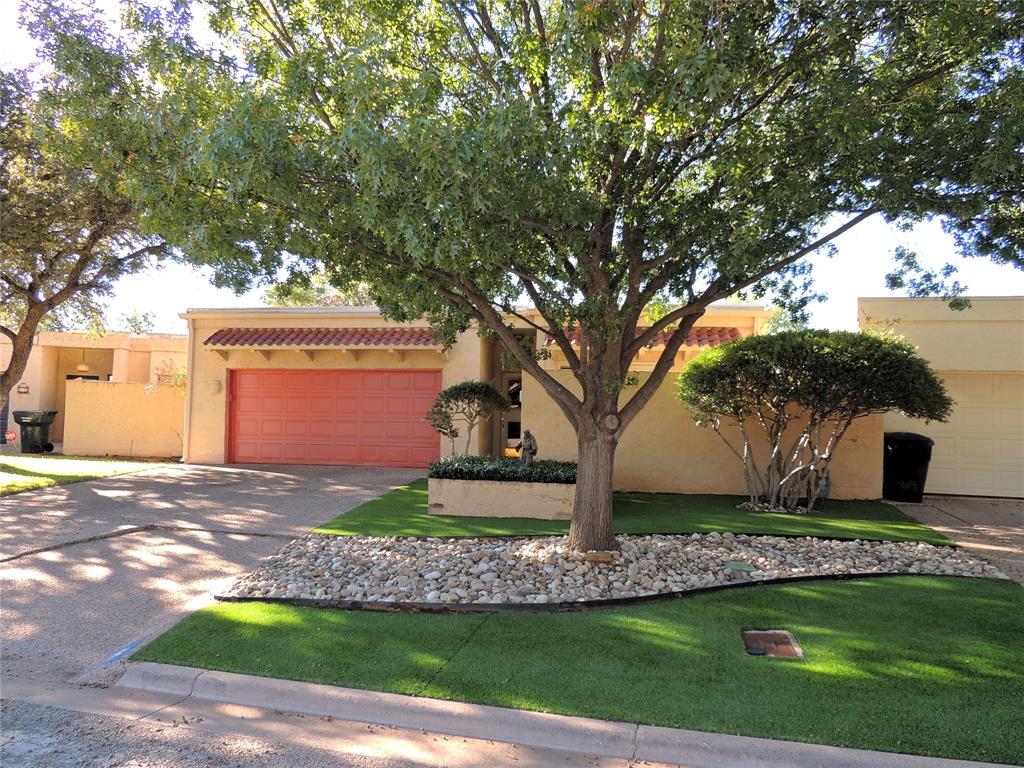 a front view of a house with a yard garage and outdoor seating