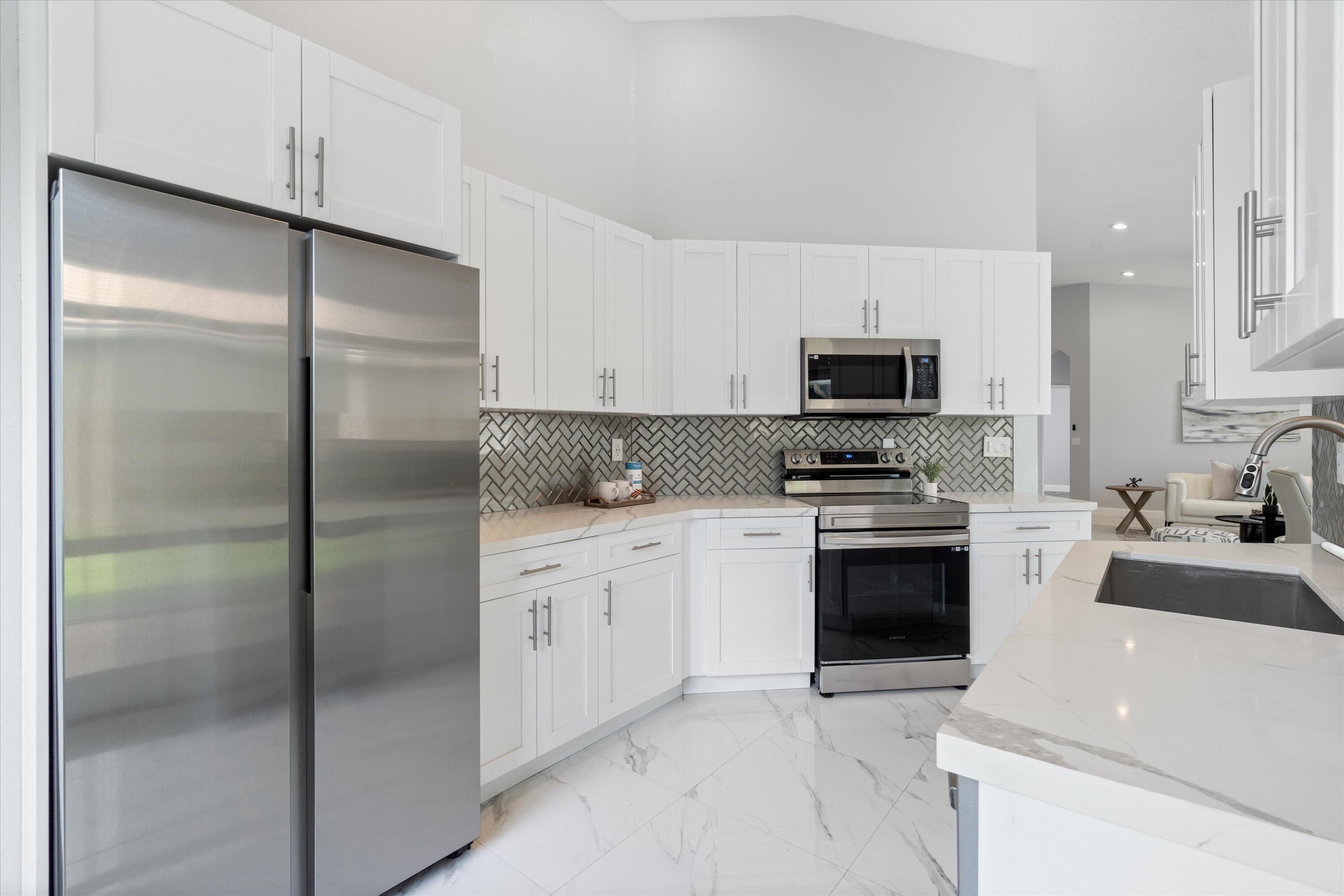 a kitchen with a refrigerator stove and microwave