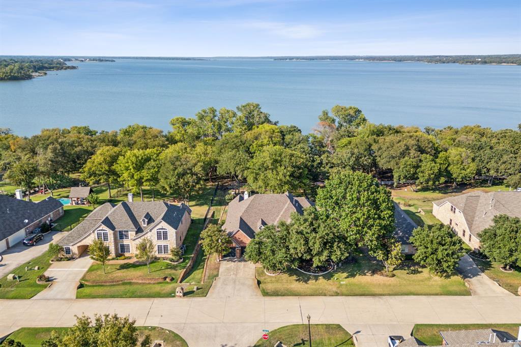 an aerial view of a house with outdoor space and lake view