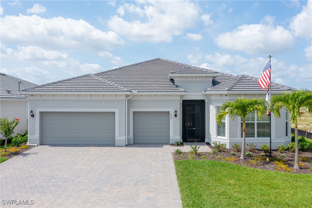 a front view of a house with a yard and garage