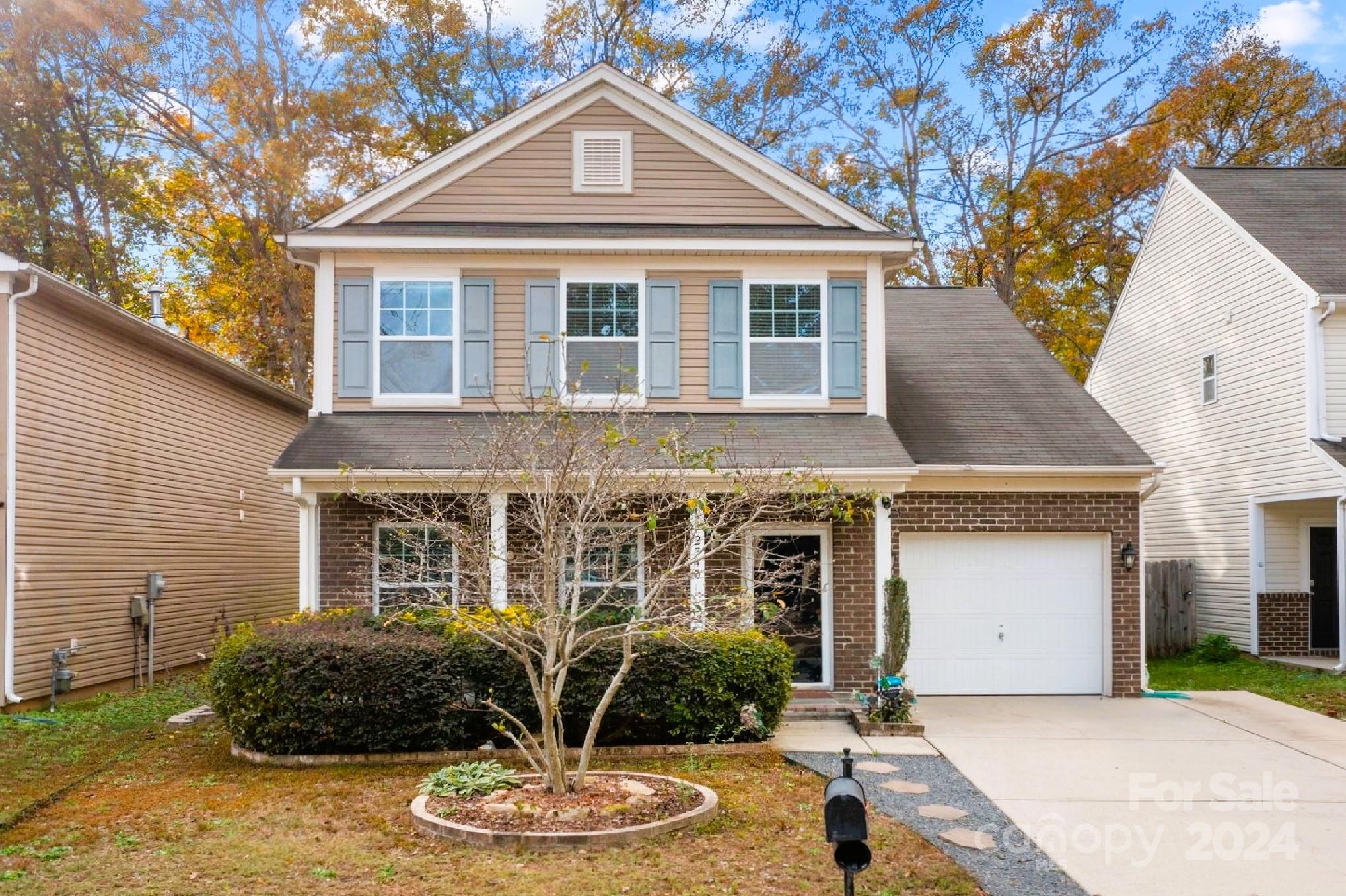 a front view of a house with garden