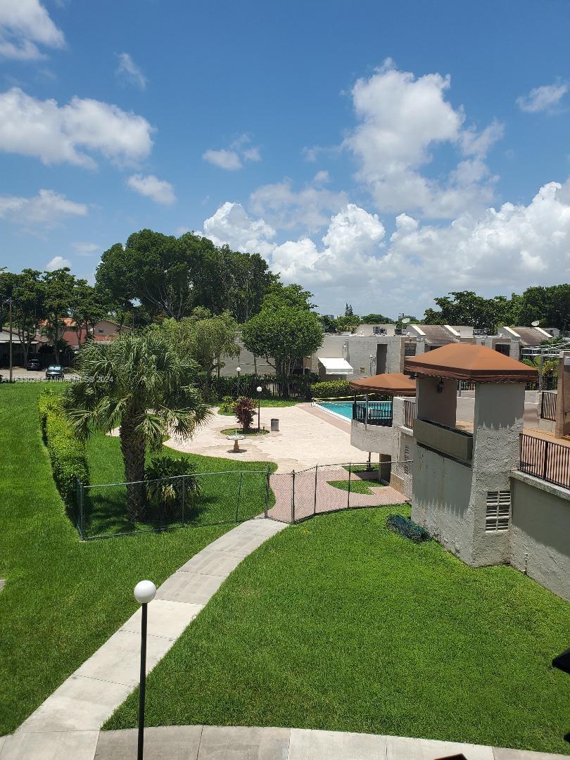 a view of a backyard with sitting area