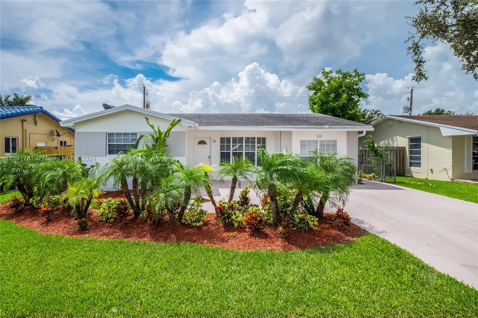 a view of an house with backyard space and garden