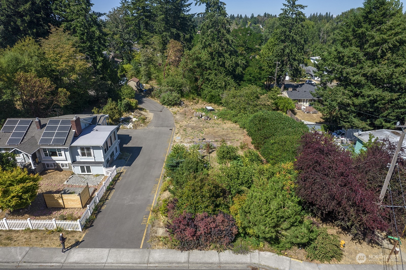 an aerial view of a house with a yard and trees