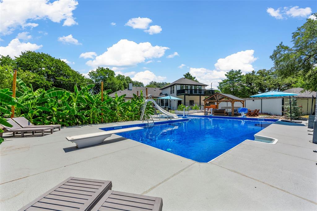 a view of a patio with swimming pool table and chairs