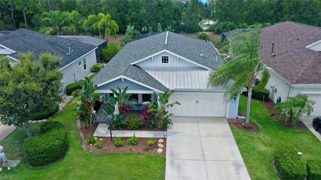 a aerial view of a house with a yard and potted plants