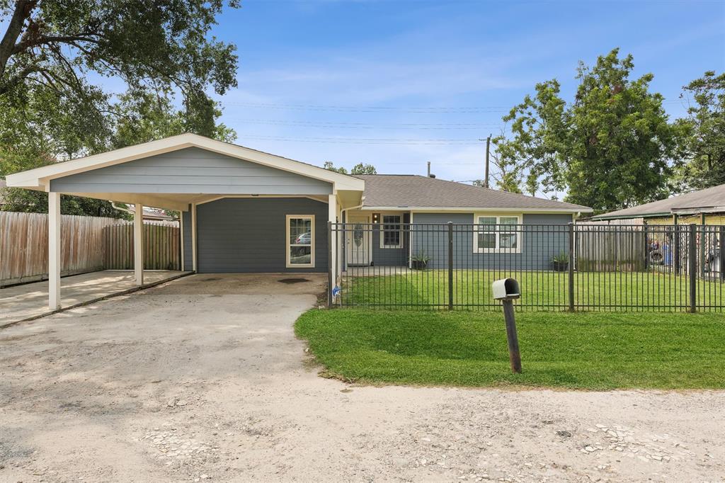 a view of a house with a backyard and a tree