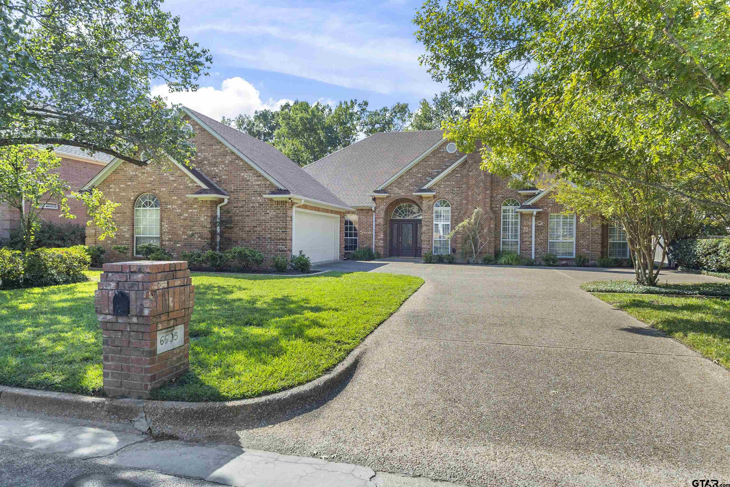 front view of a house with a garden