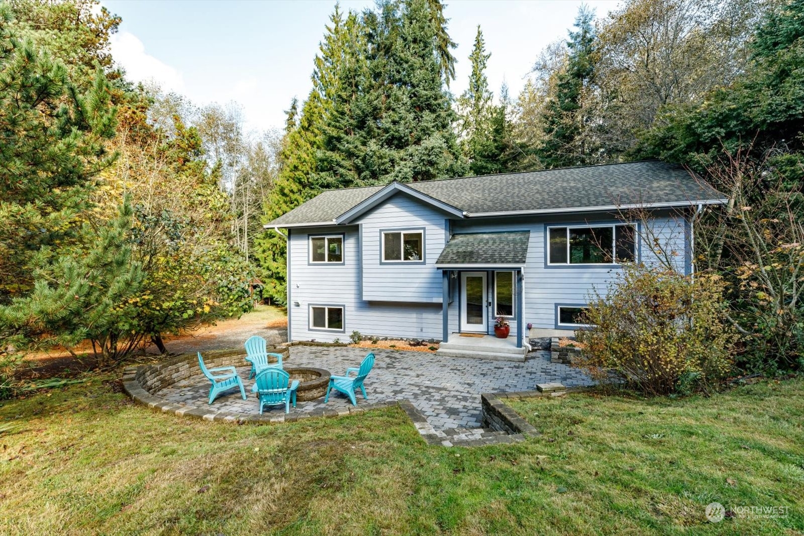 a view of a house with backyard sitting area and garden