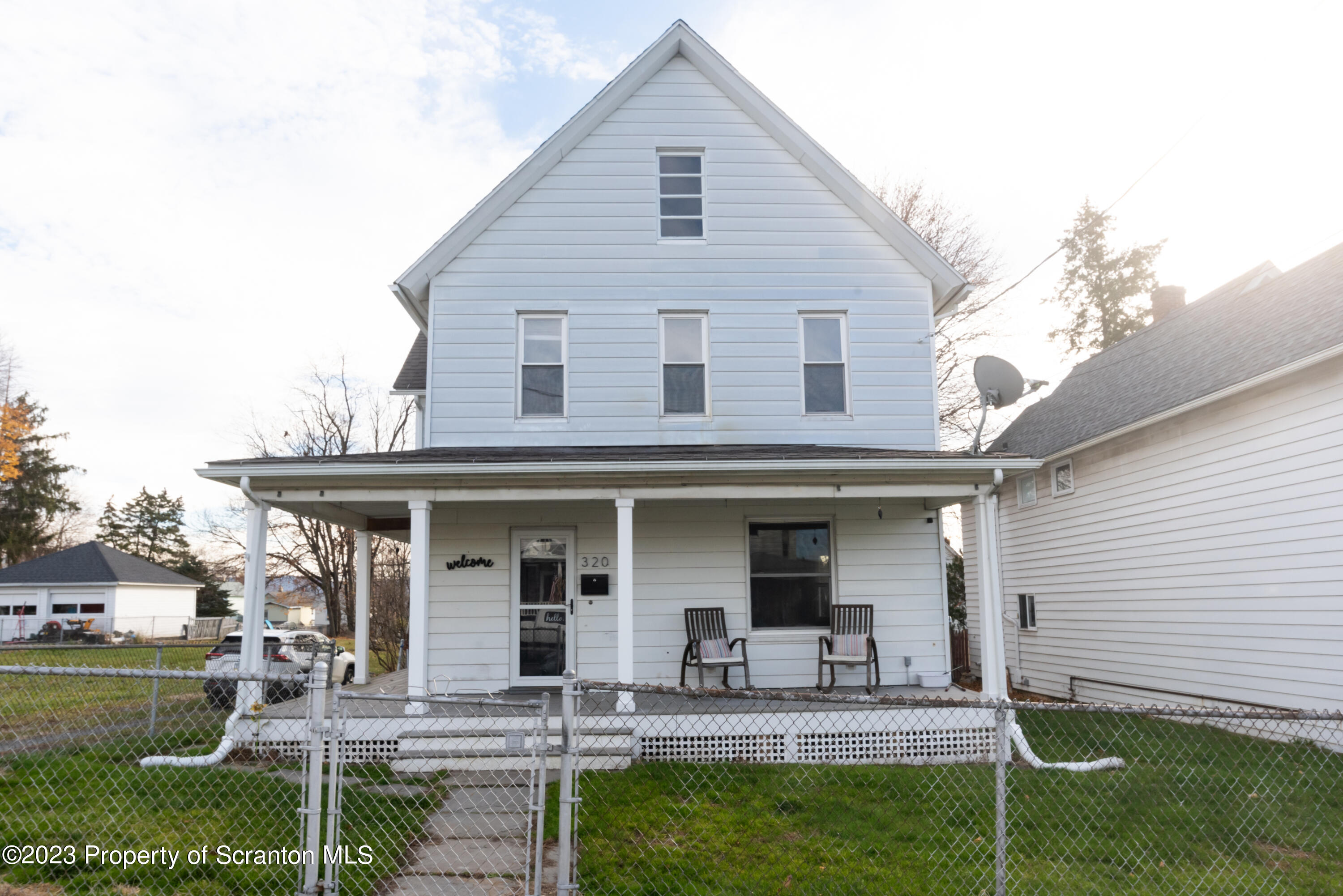 a front view of house with yard and outdoor seating