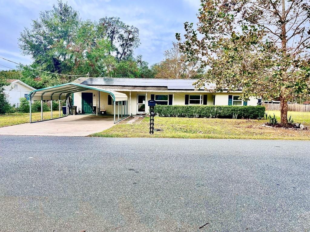 a view of house with yard and green space