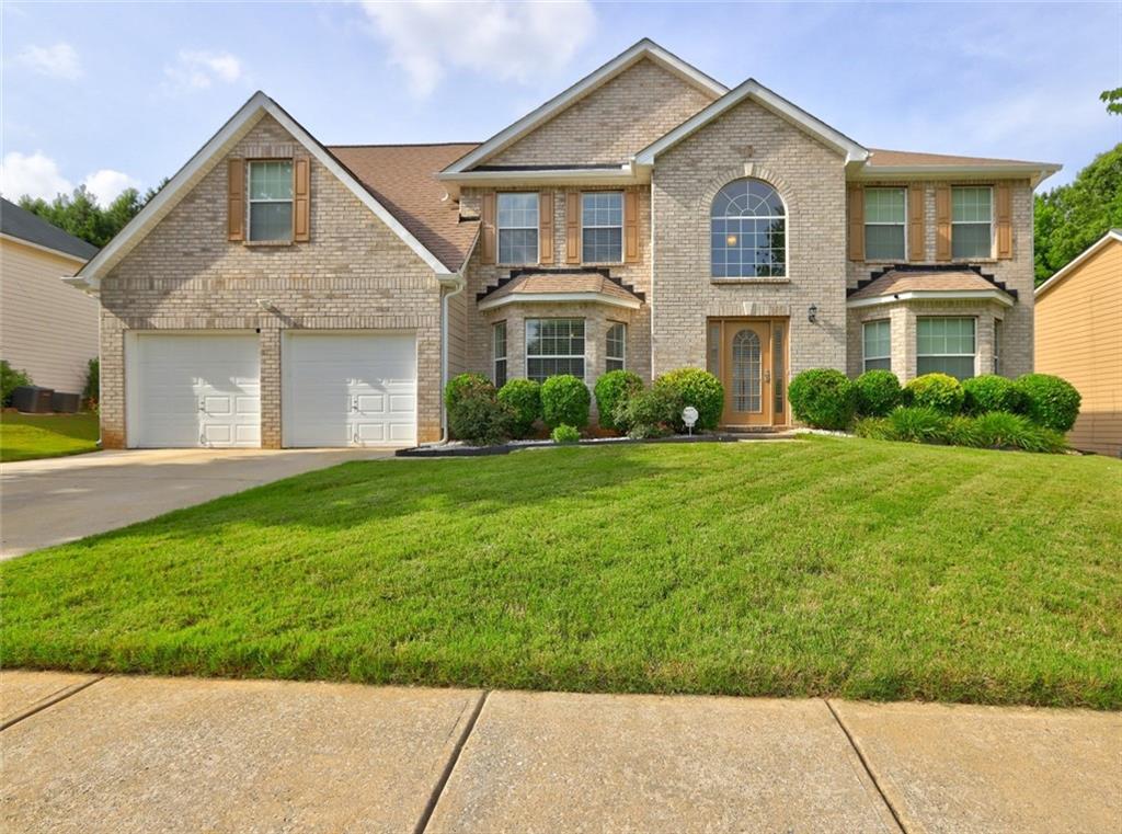 a front view of a house with a yard