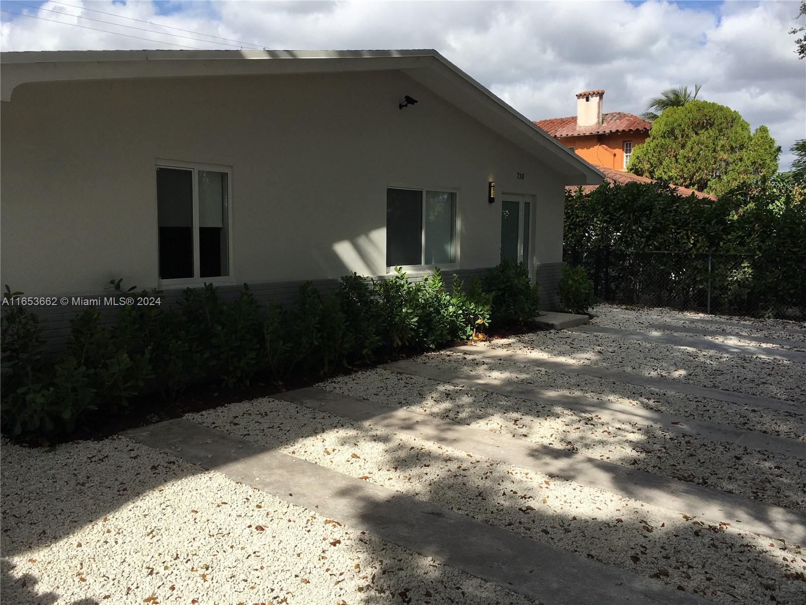 a view of a house with a backyard