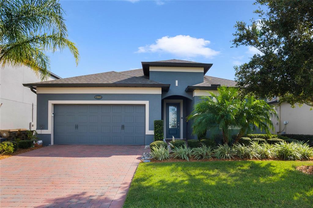 a front view of a house with a yard and garage