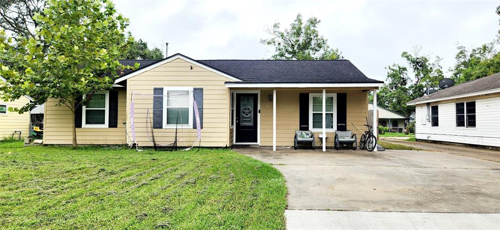 a view of a house with a yard and sitting area