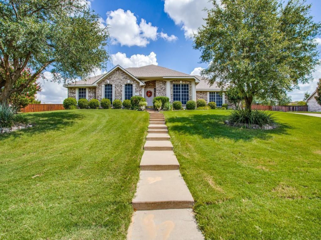 a front view of a house with yard and green space