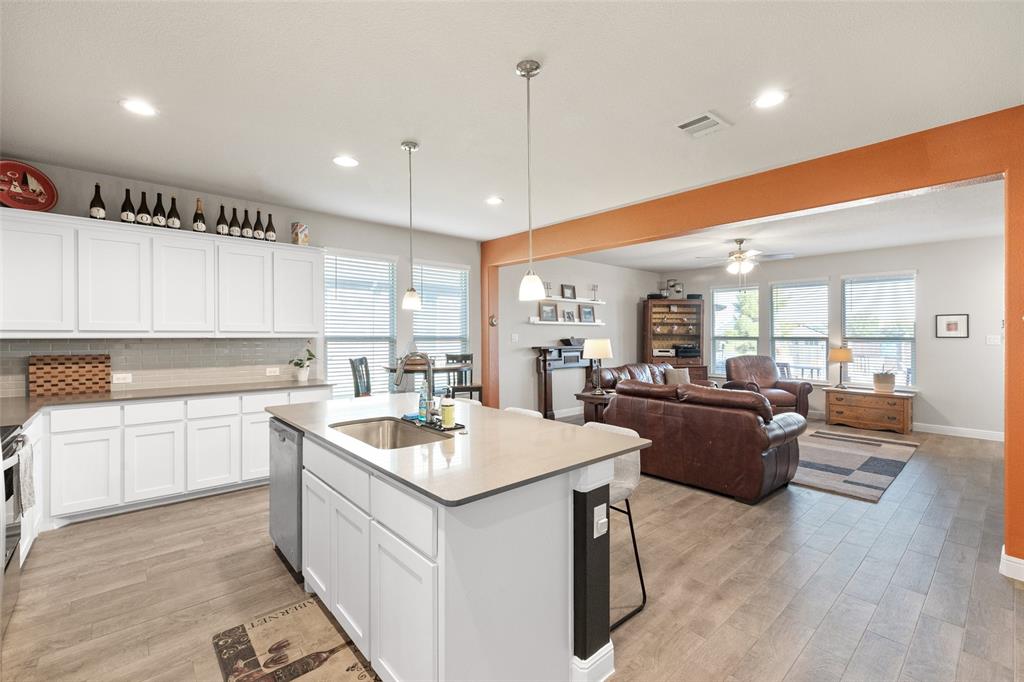 a kitchen with a sink appliances and cabinets