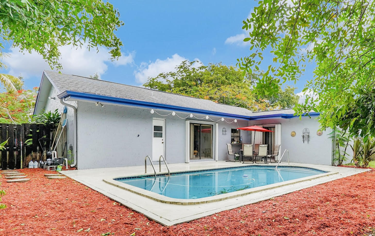 swimming pool view with a seating space