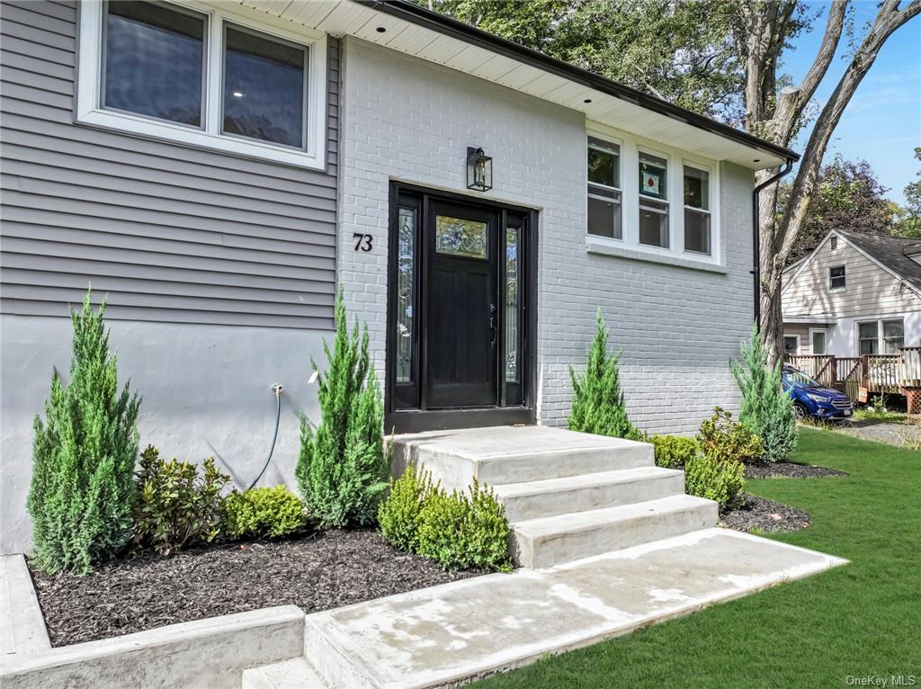 a front view of a house with garden