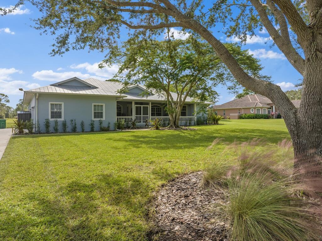 a front view of house with yard and green space