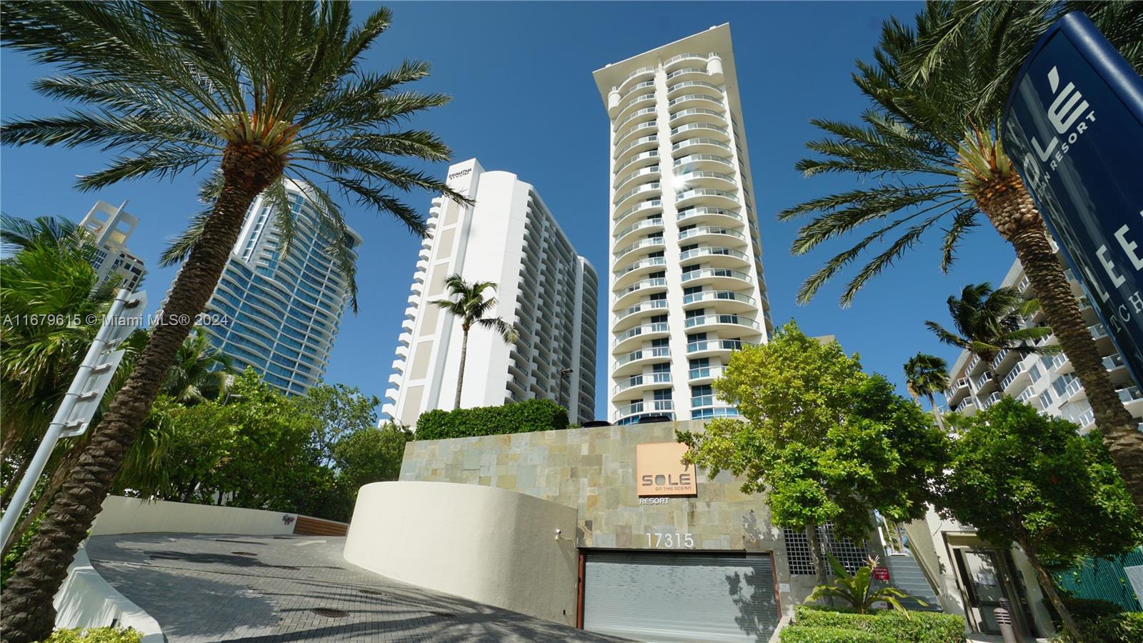 a view of a tall building with the tree in front