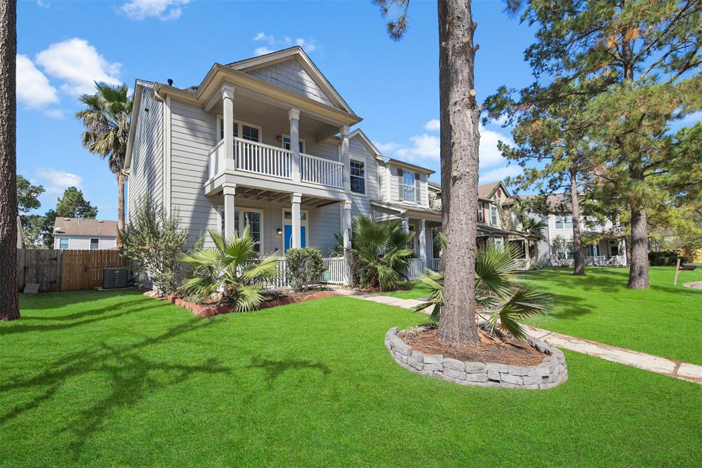 a front view of a house with a yard and fountain