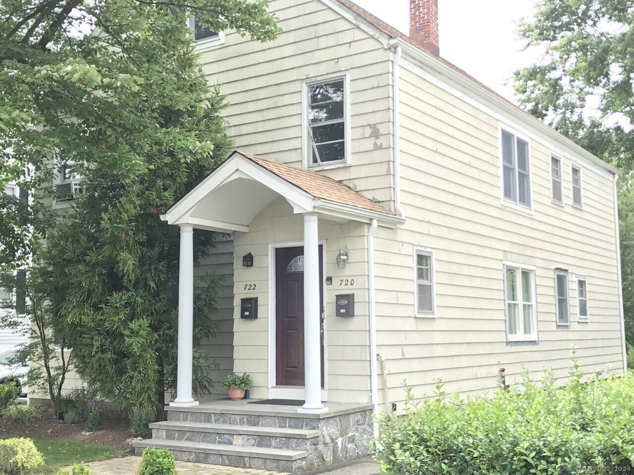 a view of a house with a yard and balcony