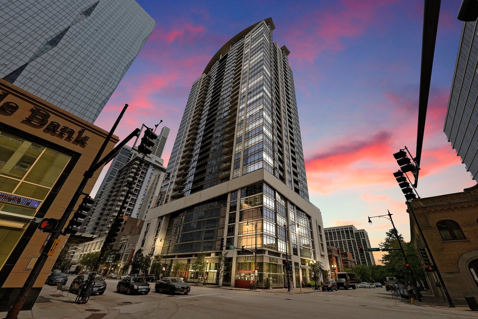 a view of a tall building next to a road