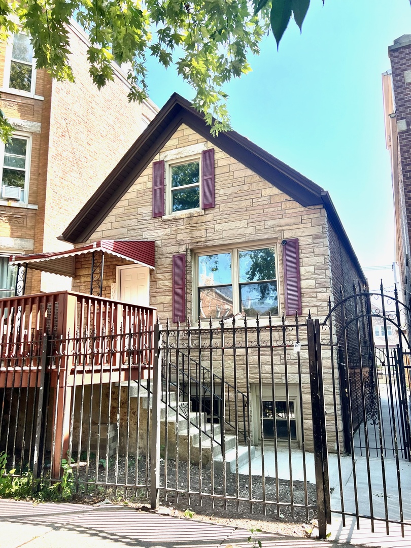 a view of a brick house with large windows