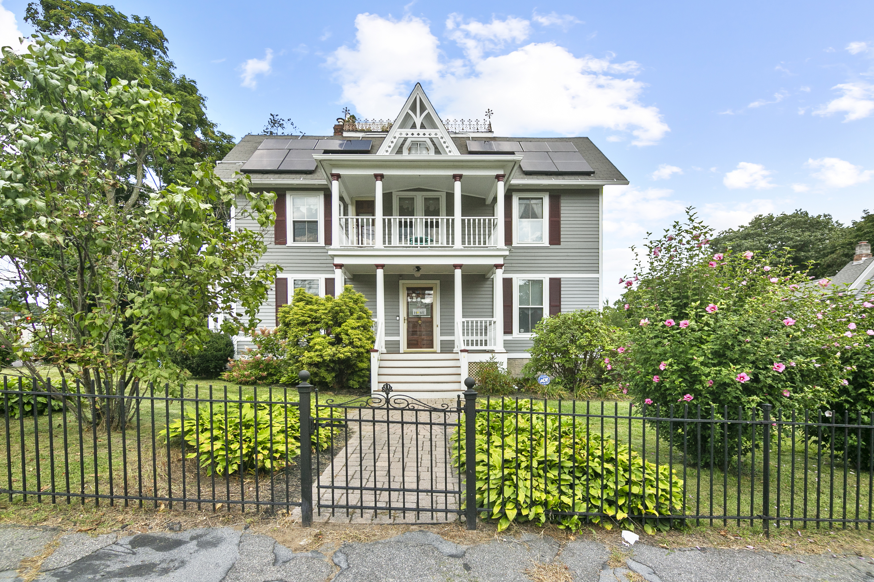 a front view of a house with a garden