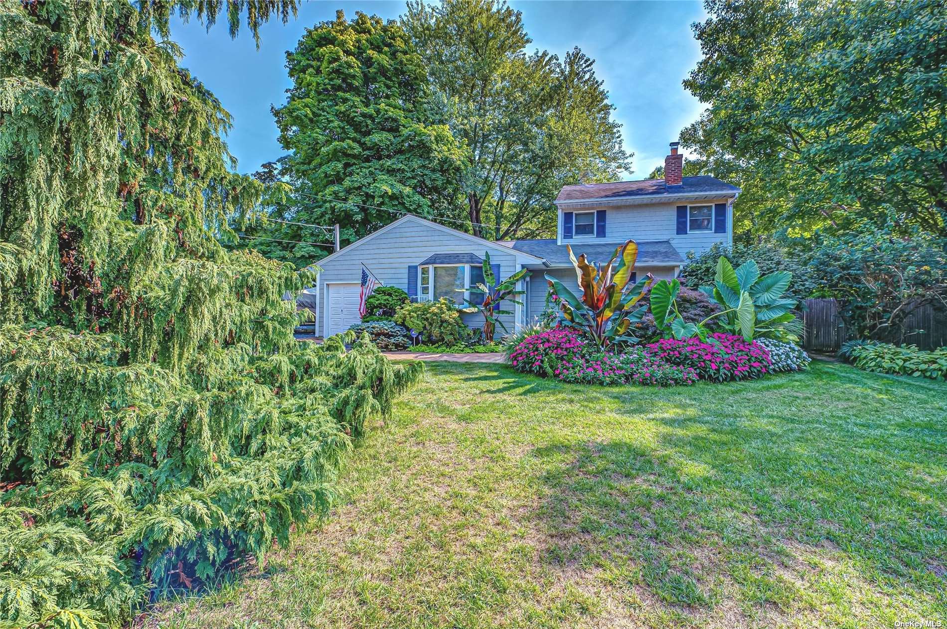 a view of a house with a yard and garden