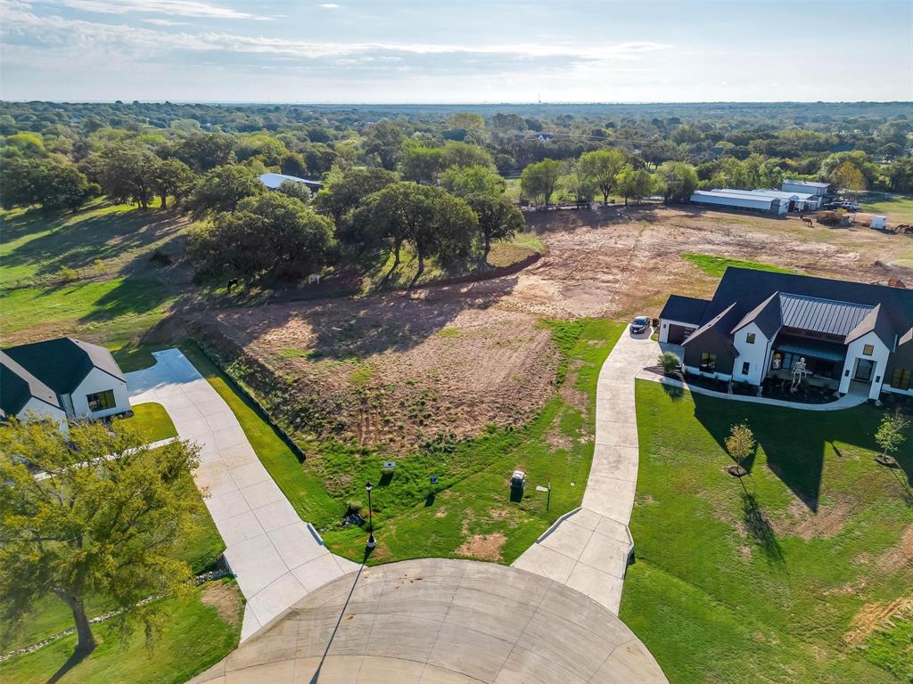 an aerial view of a house with a garden and lake view