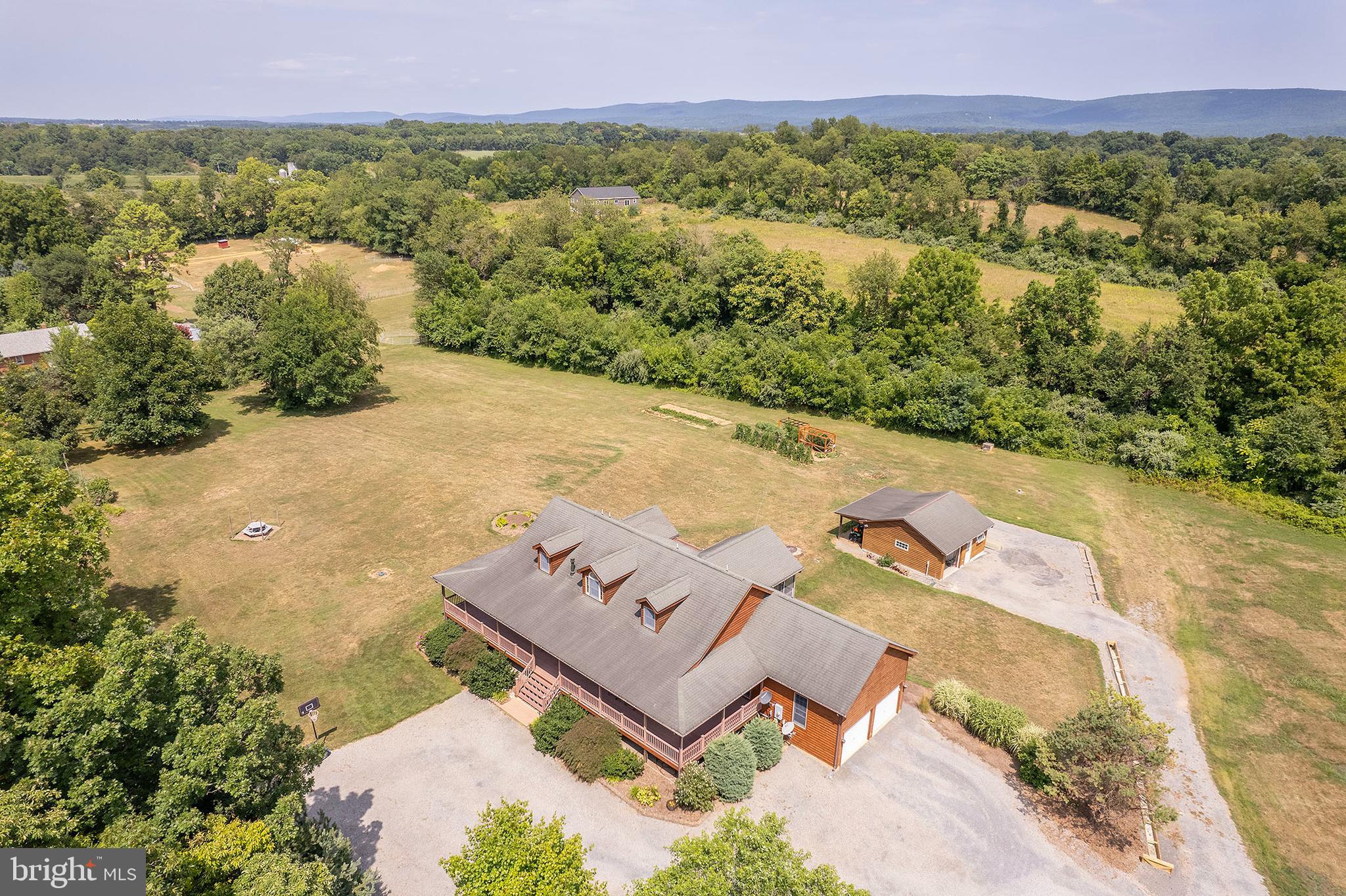 an aerial view of a house with a yard and lake view